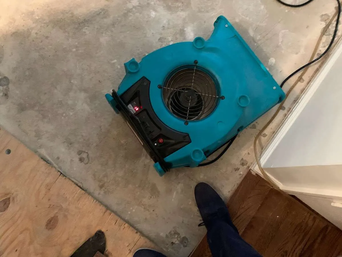 Air mover drying subfloor during Commercial Water Damage Restoration in South Brunswick